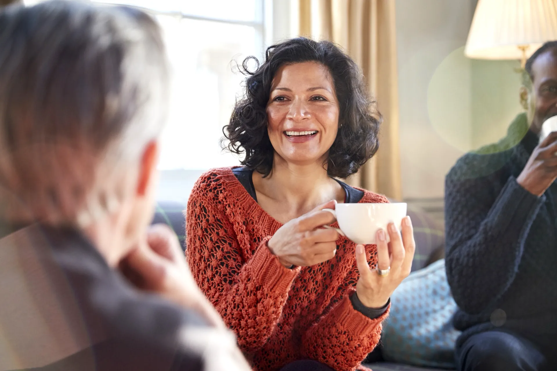 women enjoying a cup of tea among friends
